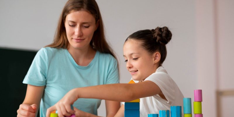 psychologist-helping-girl-speech-therapy 1